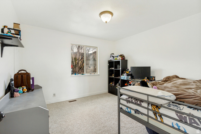 1585 South 910 West Payson, UT 84651 - Photo 19 of 32 Bright room featuring a double window, neutral carpeting, and a ceiling-mounted light fixture