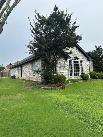an empty room with wooden floor chandelier and closet