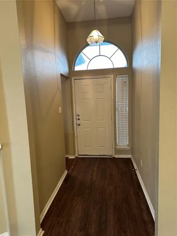 wooden floor in an empty room with a mirror