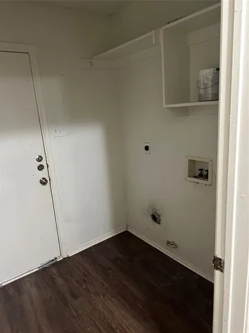 a view of an empty room with a fireplace and a window