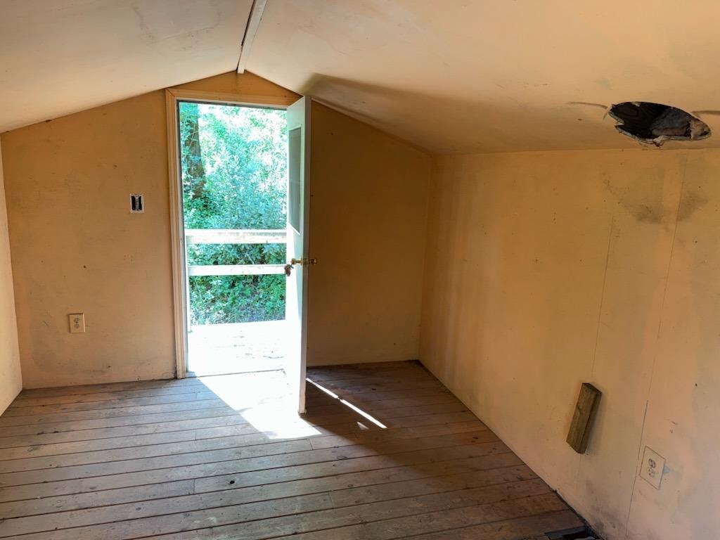 303 Stone House Road Auburn, CA 95603 - Photo 11 of 26 a view of an empty room with wooden floor and a window