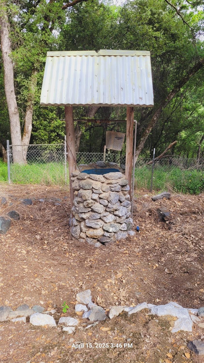 303 Stone House Road Auburn, CA 95603 - Photo 13 of 26 a view of a back yard with a patio