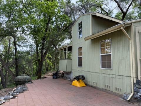 303 Stone House Road Auburn, CA 95603 - Photo 6 of 26 a view of a house with a yard and sitting area