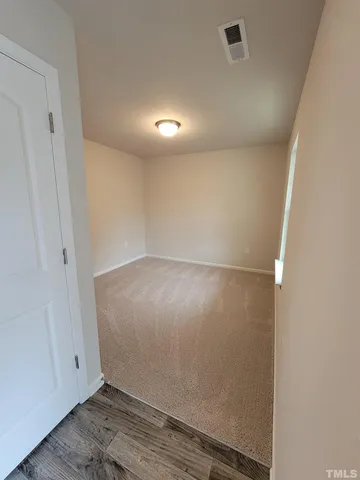 an empty room with wooden floor