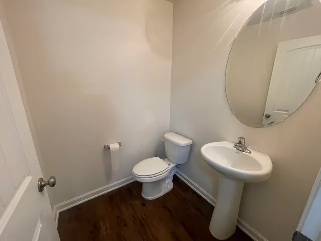 a bathroom with a sink toilet and a mirror