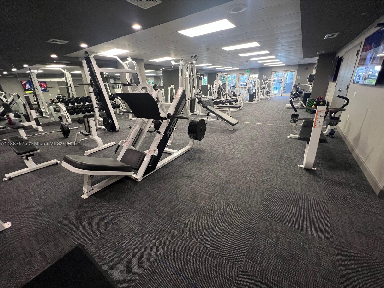185 Southeast 14th Terrace, Unit 910 Miami, FL 33131 - Photo 11 of 12 a view of a room with gym equipment