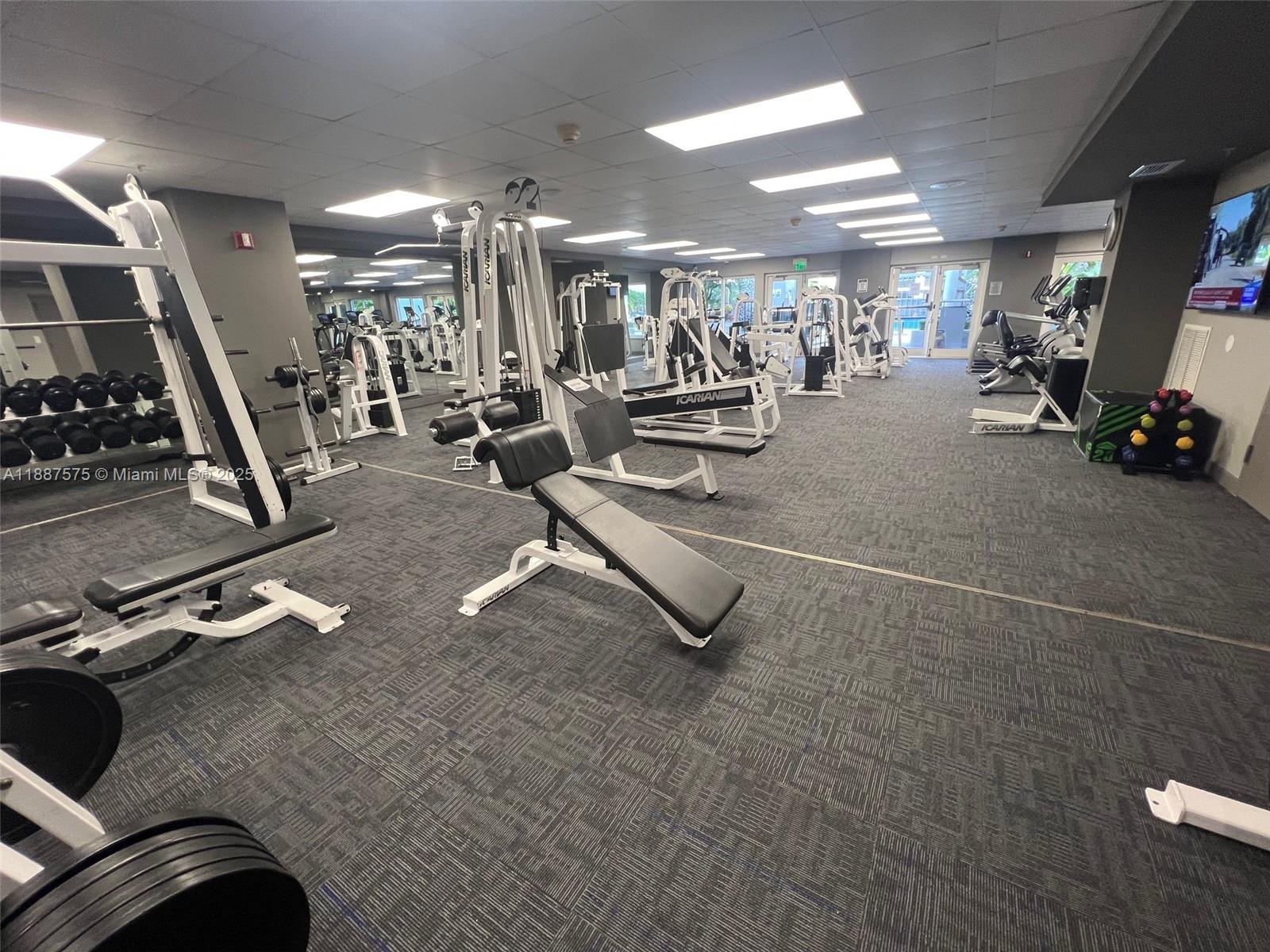 185 Southeast 14th Terrace, Unit 910 Miami, FL 33131 - Photo 12 of 12 a view of a room with gym equipment