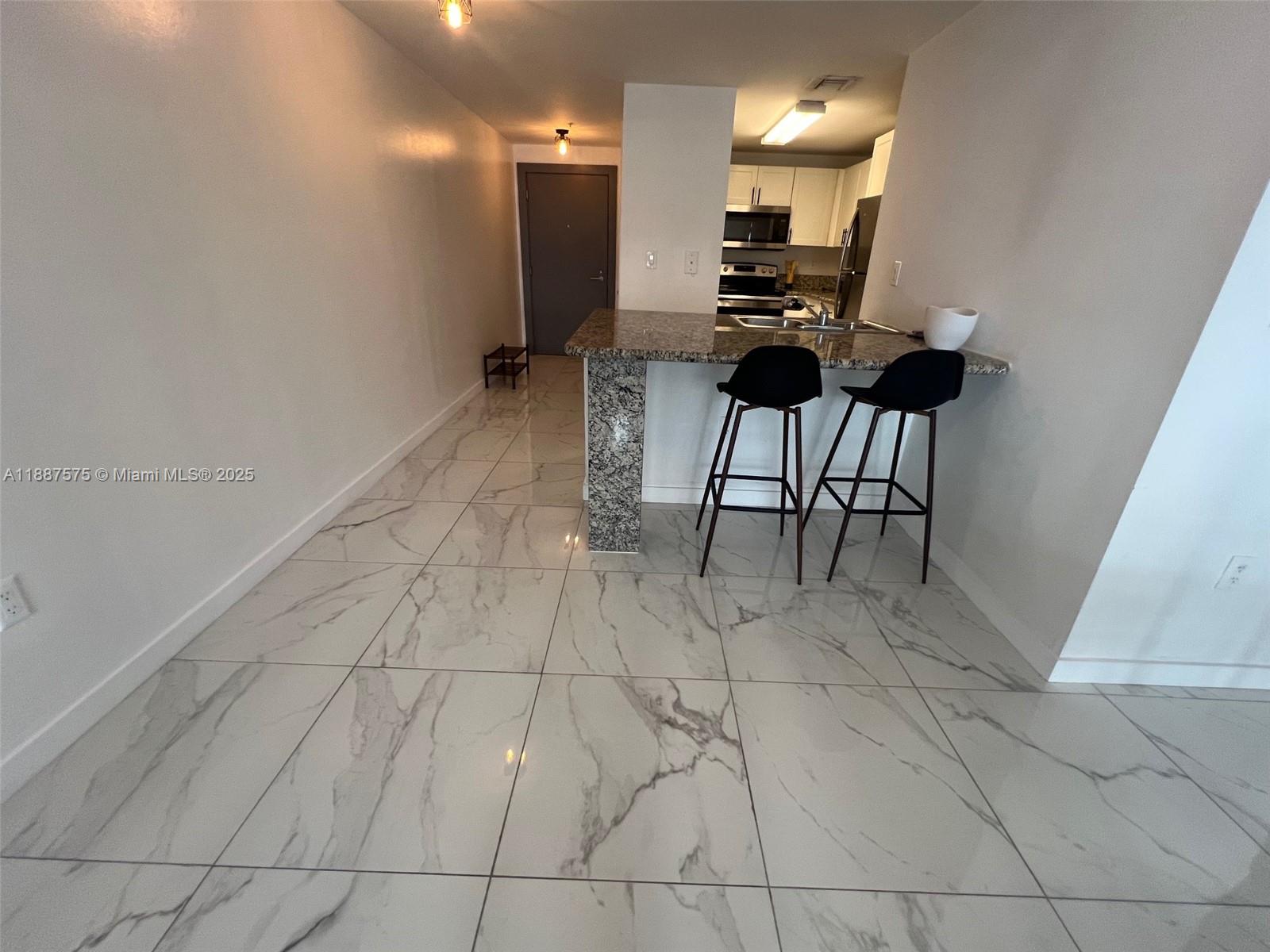 185 Southeast 14th Terrace, Unit 910 Miami, FL 33131 - Photo 3 of 12 a view of a workspace with furniture