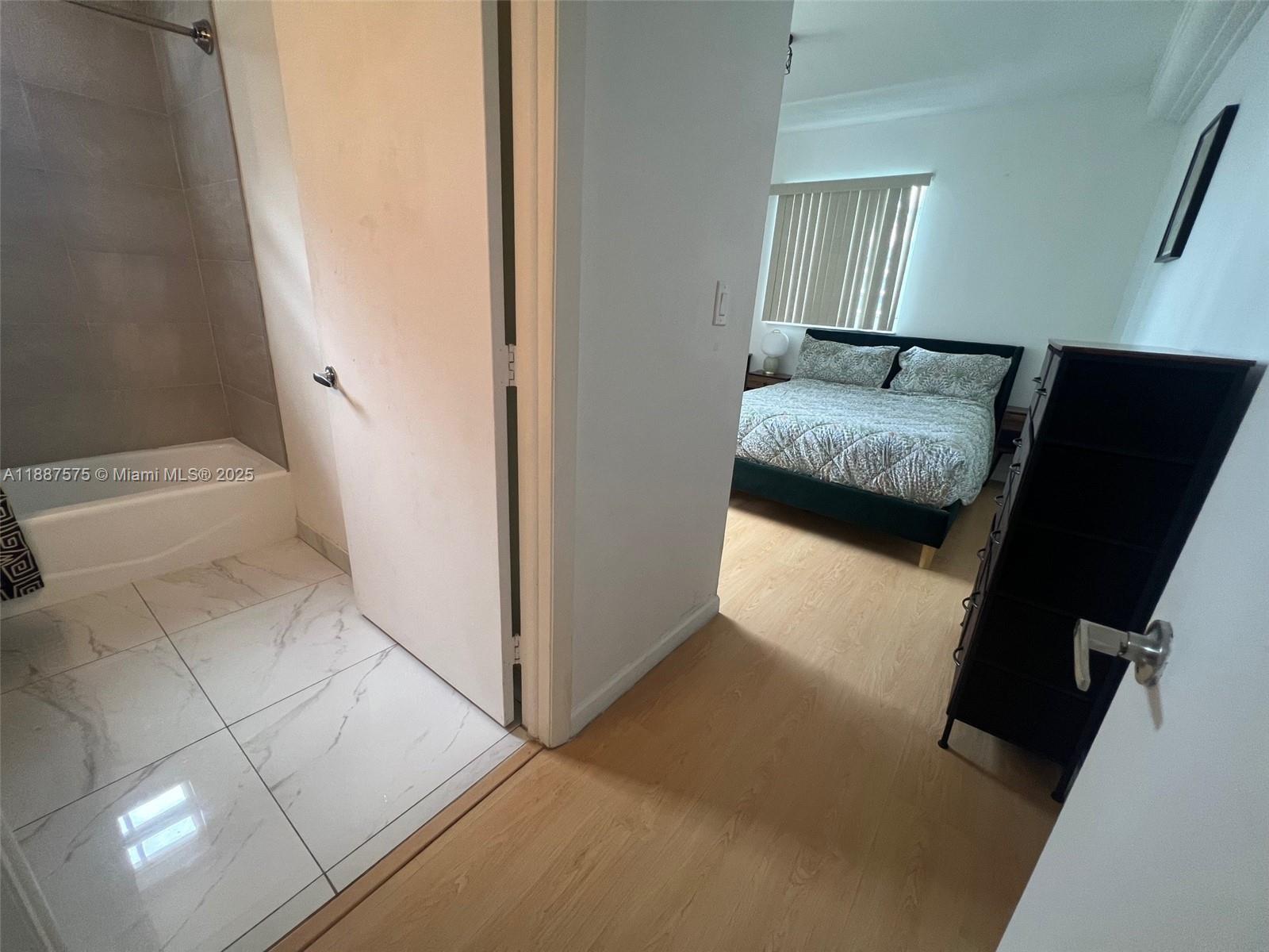 185 Southeast 14th Terrace, Unit 910 Miami, FL 33131 - Photo 4 of 12 a en suite bathroom with a sink and a mirror