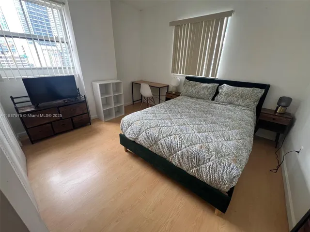 a bedroom with bed and window