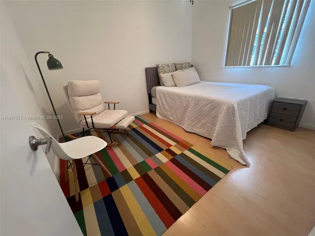 a bedroom with two beds and a rug