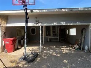 an empty room with wooden floor ceiling fan and windows