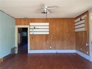 an empty room with wooden floor and a window