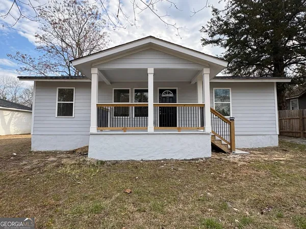 a house with trees in the background