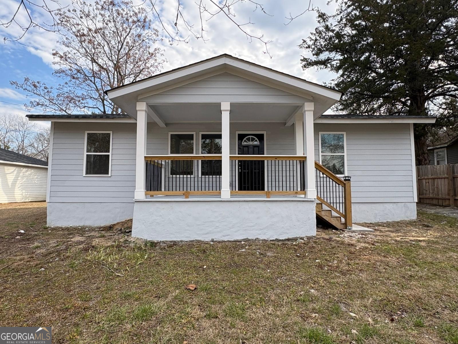 a house with trees in the background