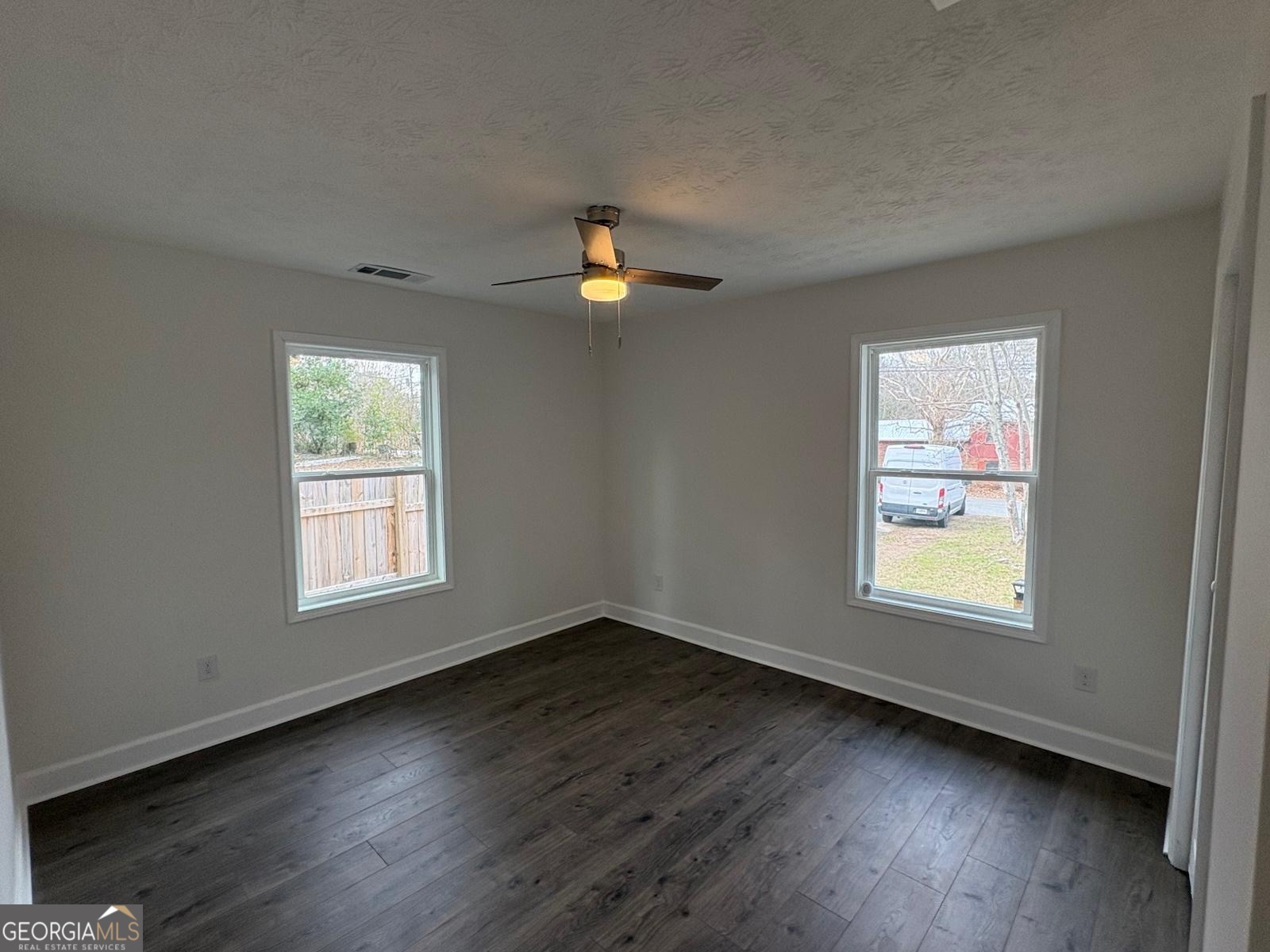 7724 Boulder Drive Columbus, GA 31909 - Photo 4 of 9 a view of an empty room with wooden floor and a window