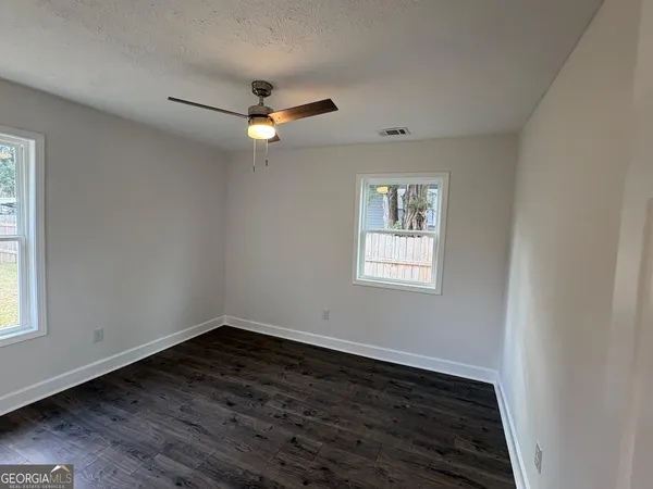 wooden floor in an empty room with a window