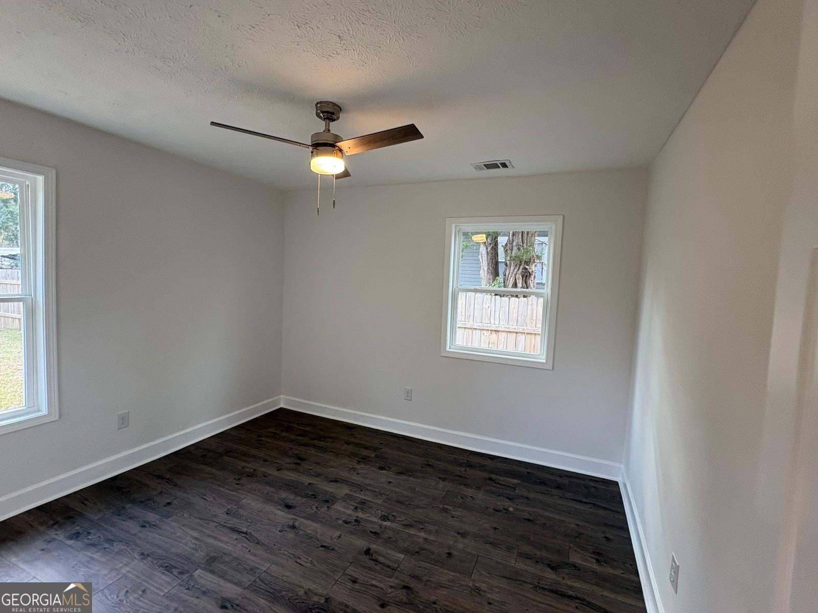 7724 Boulder Drive Columbus, GA 31909 - Photo 6 of 9 wooden floor in an empty room with a window