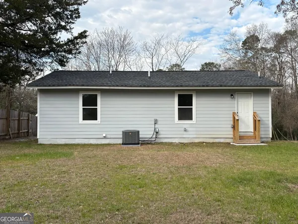 a house that has a tree in front of it