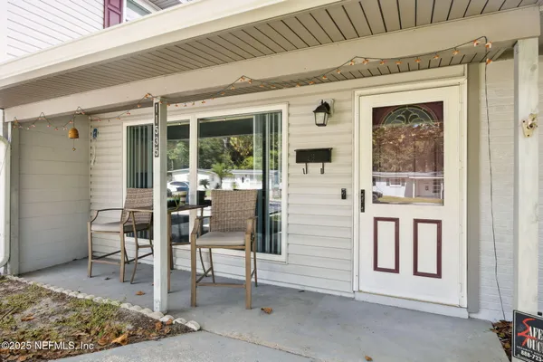 a front view of a house with outdoor seating