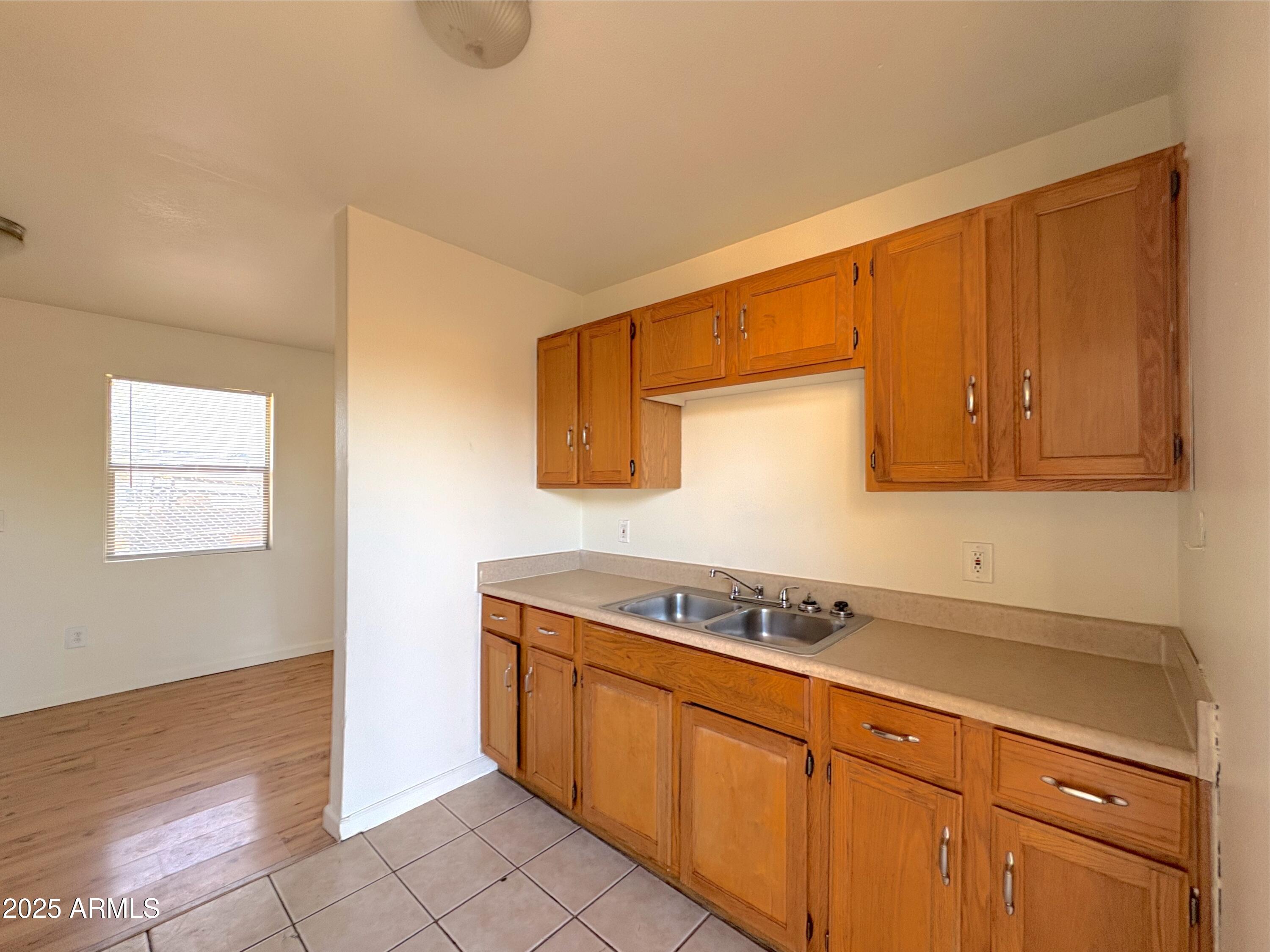 425 North 18th Drive, Unit 3 Phoenix, AZ 85007 - Photo 4 of 10 a kitchen with stainless steel appliances granite countertop a sink and cabinets