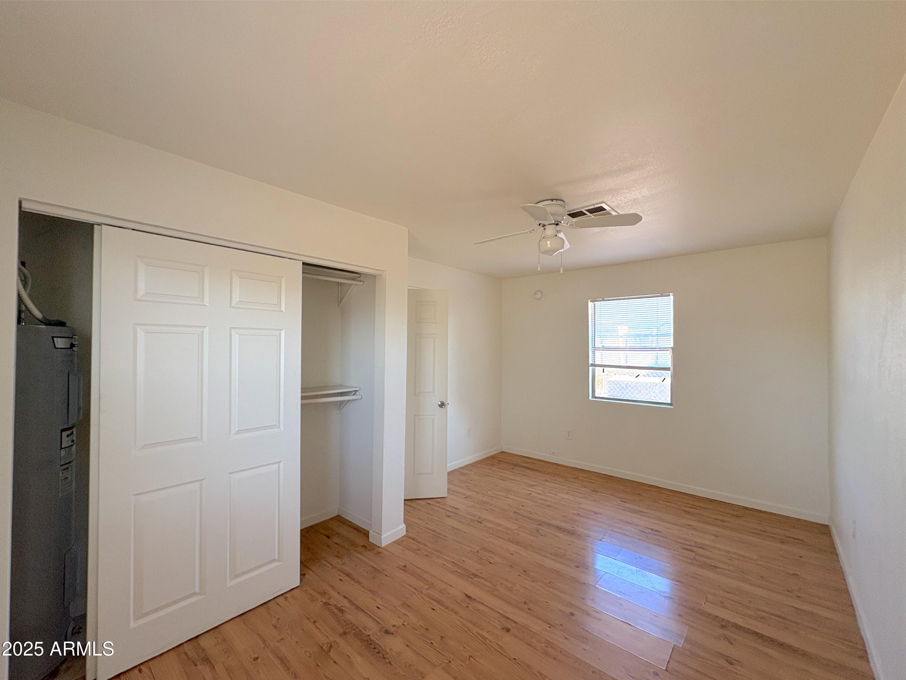 425 North 18th Drive, Unit 3 Phoenix, AZ 85007 - Photo 7 of 10 a view of an empty room with wooden floor and a window