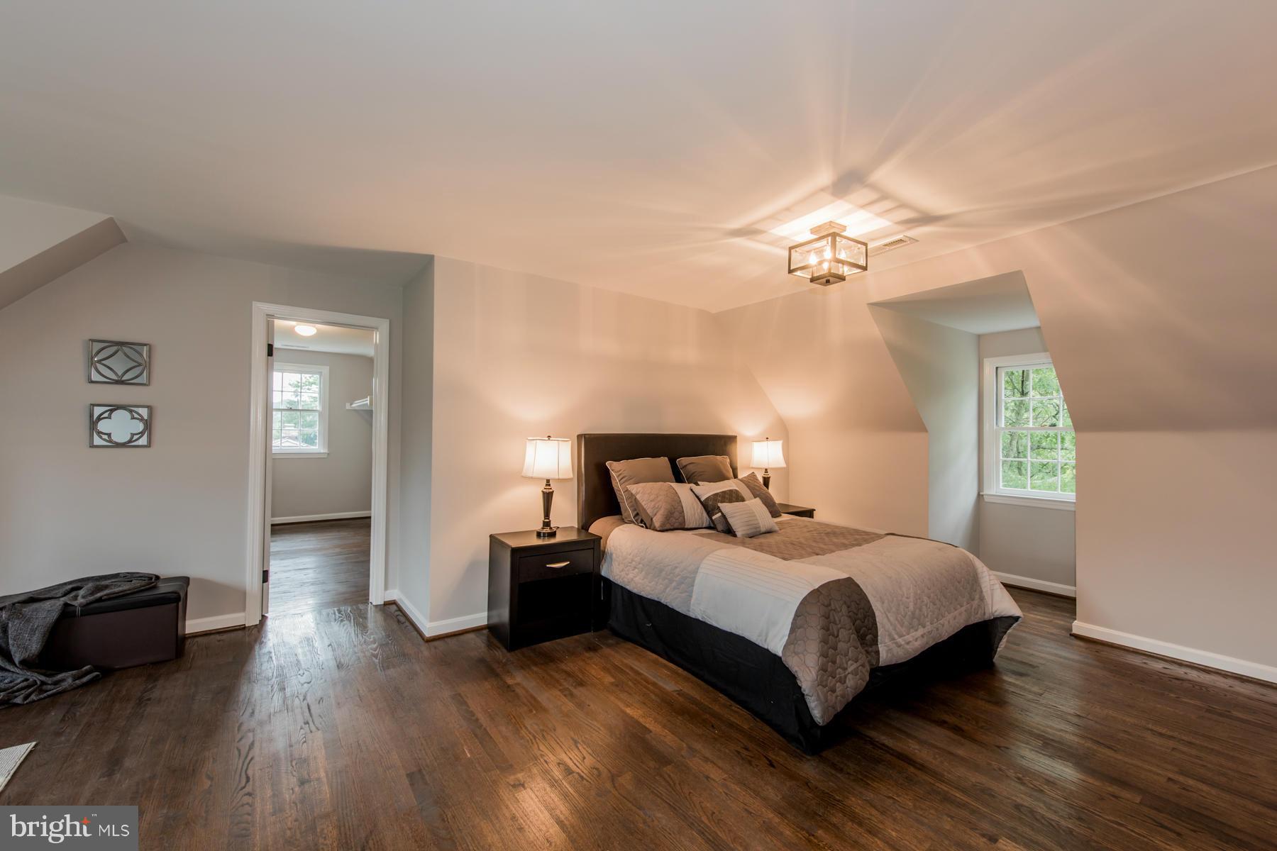 9105 Waycross Road Ellicott City, MD 21042 - Photo 13 of 27 a bedroom with a bed and a wooden floor