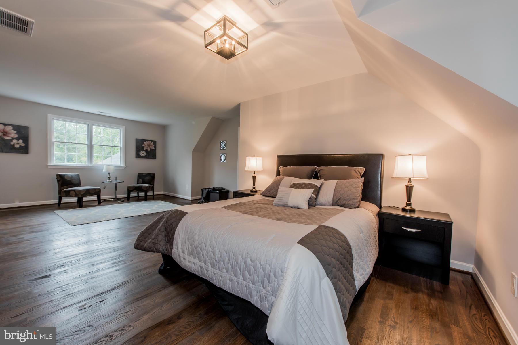 9105 Waycross Road Ellicott City, MD 21042 - Photo 14 of 27 a spacious bedroom with a bed and wooden floor