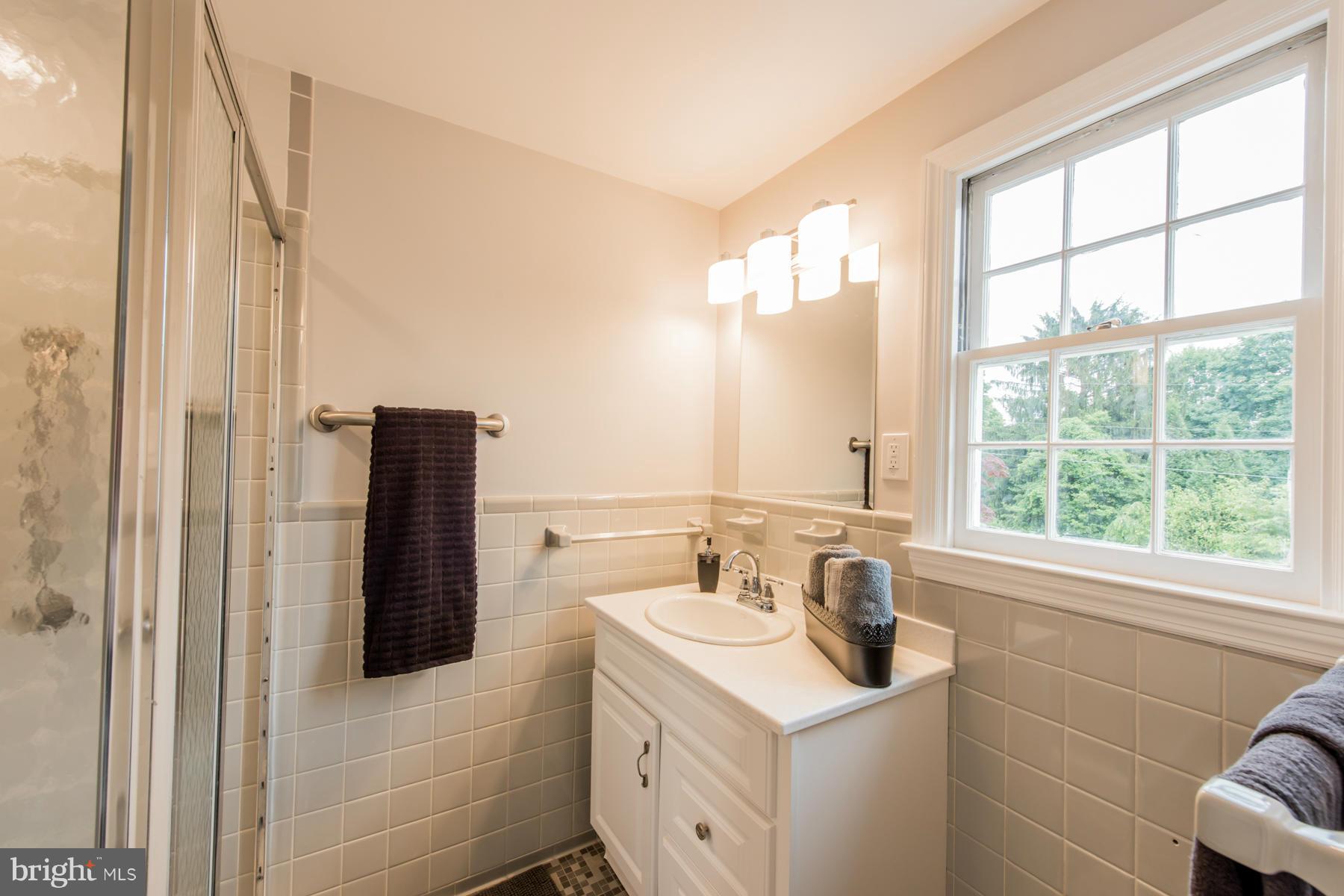 9105 Waycross Road Ellicott City, MD 21042 - Photo 16 of 27 a bathroom with a sink and a tub