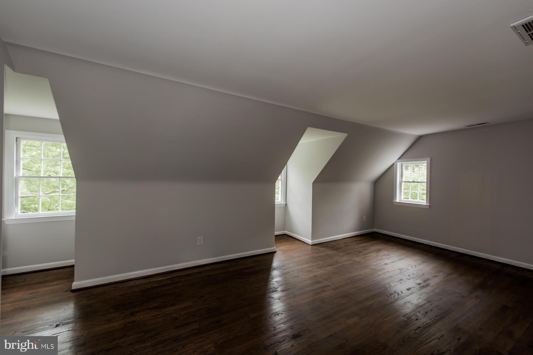9105 Waycross Road Ellicott City, MD 21042 - Photo 17 of 27 an empty room with wooden floor and windows