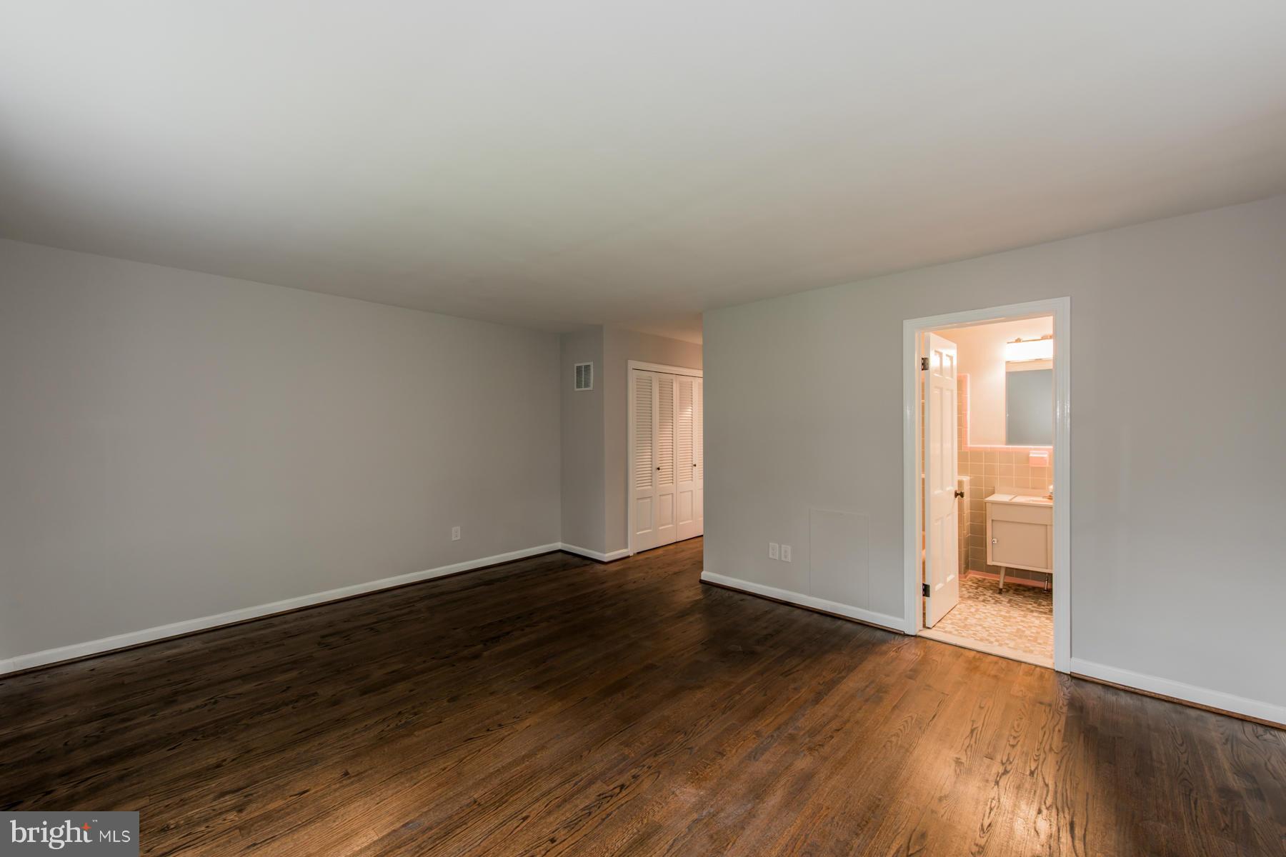 9105 Waycross Road Ellicott City, MD 21042 - Photo 19 of 27 a view of an empty room and wooden floor
