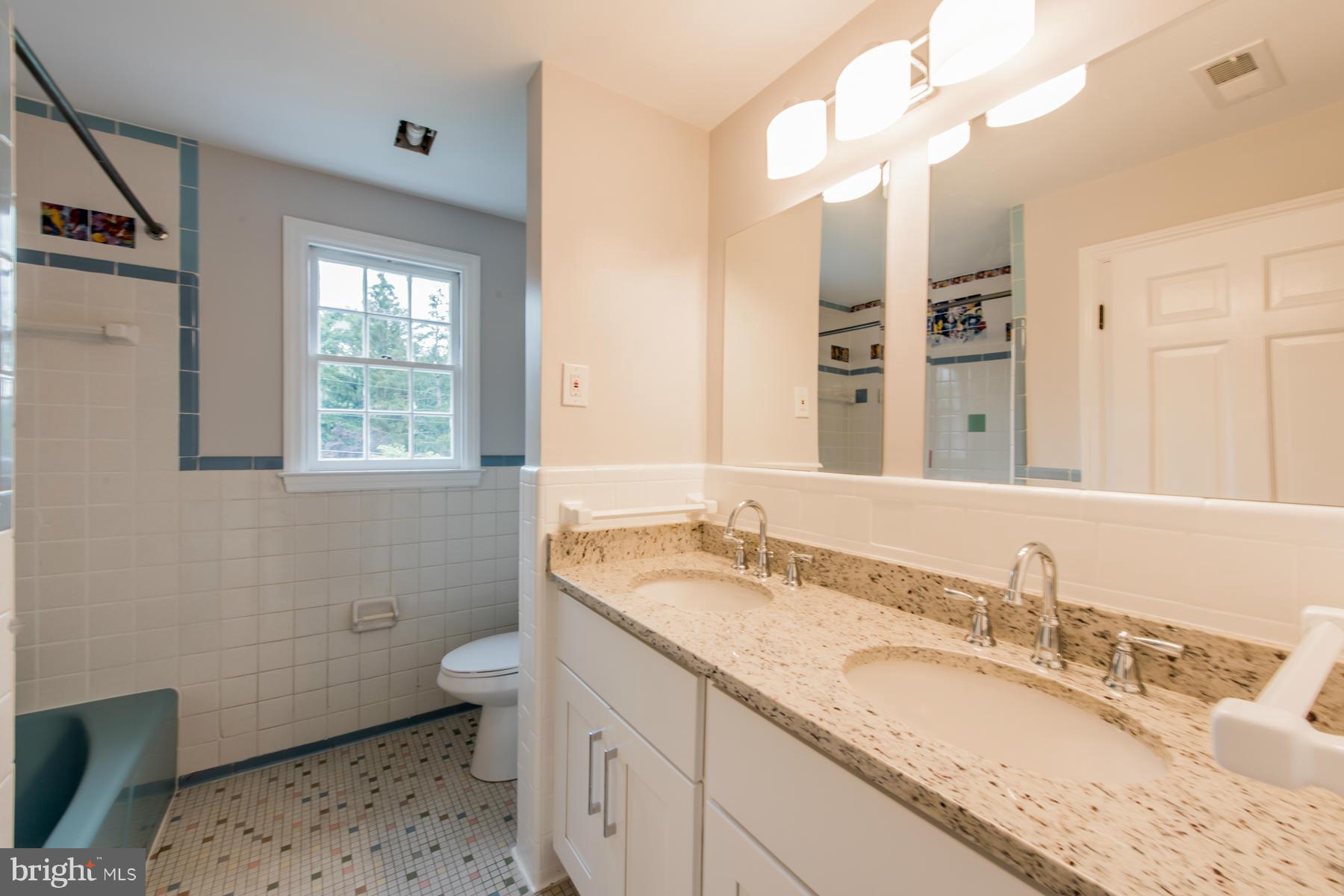 9105 Waycross Road Ellicott City, MD 21042 - Photo 22 of 27 a bathroom with a granite countertop double vanity sink a mirror and a toilet
