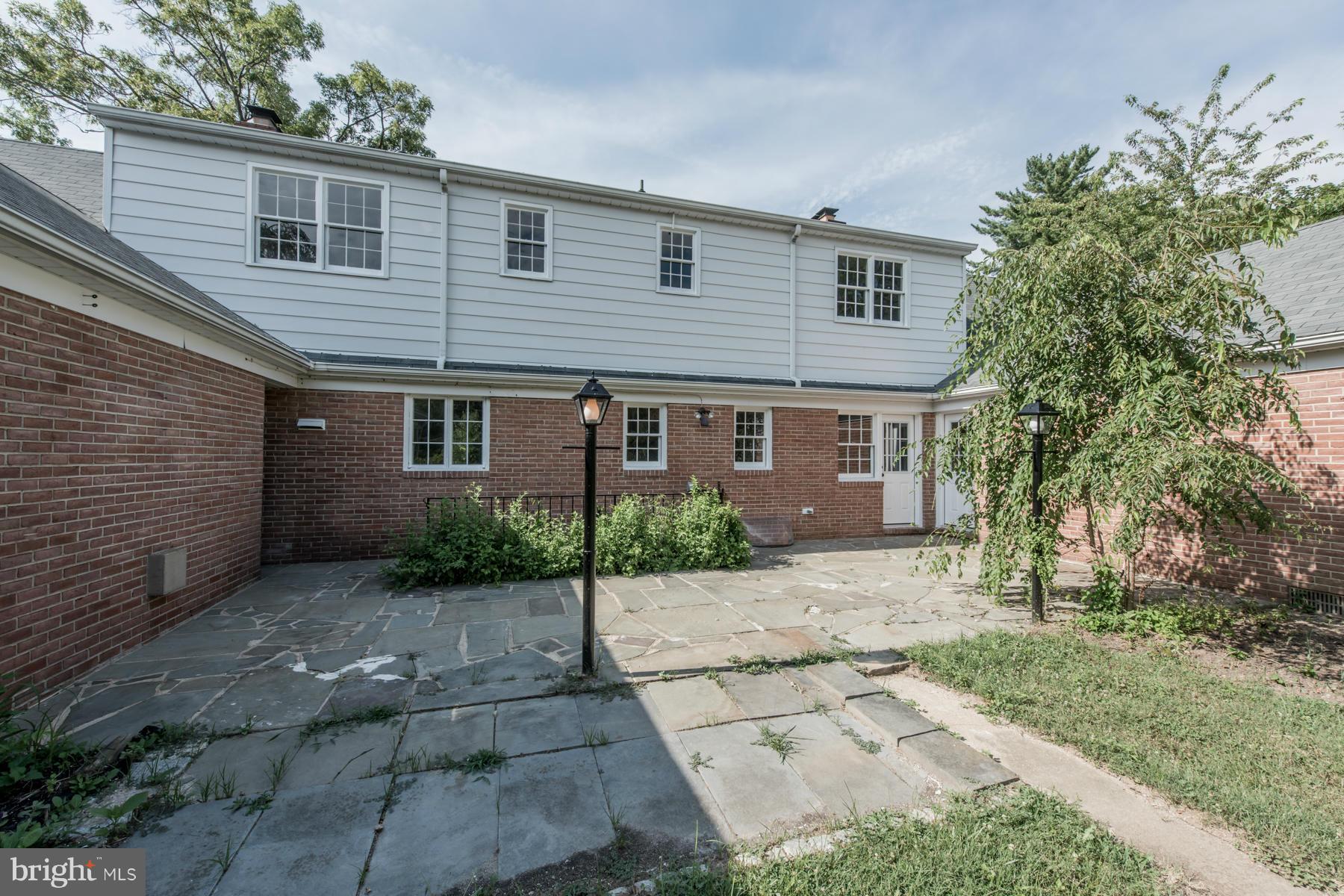 9105 Waycross Road Ellicott City, MD 21042 - Photo 23 of 27 a front view of a house with a yard and garage