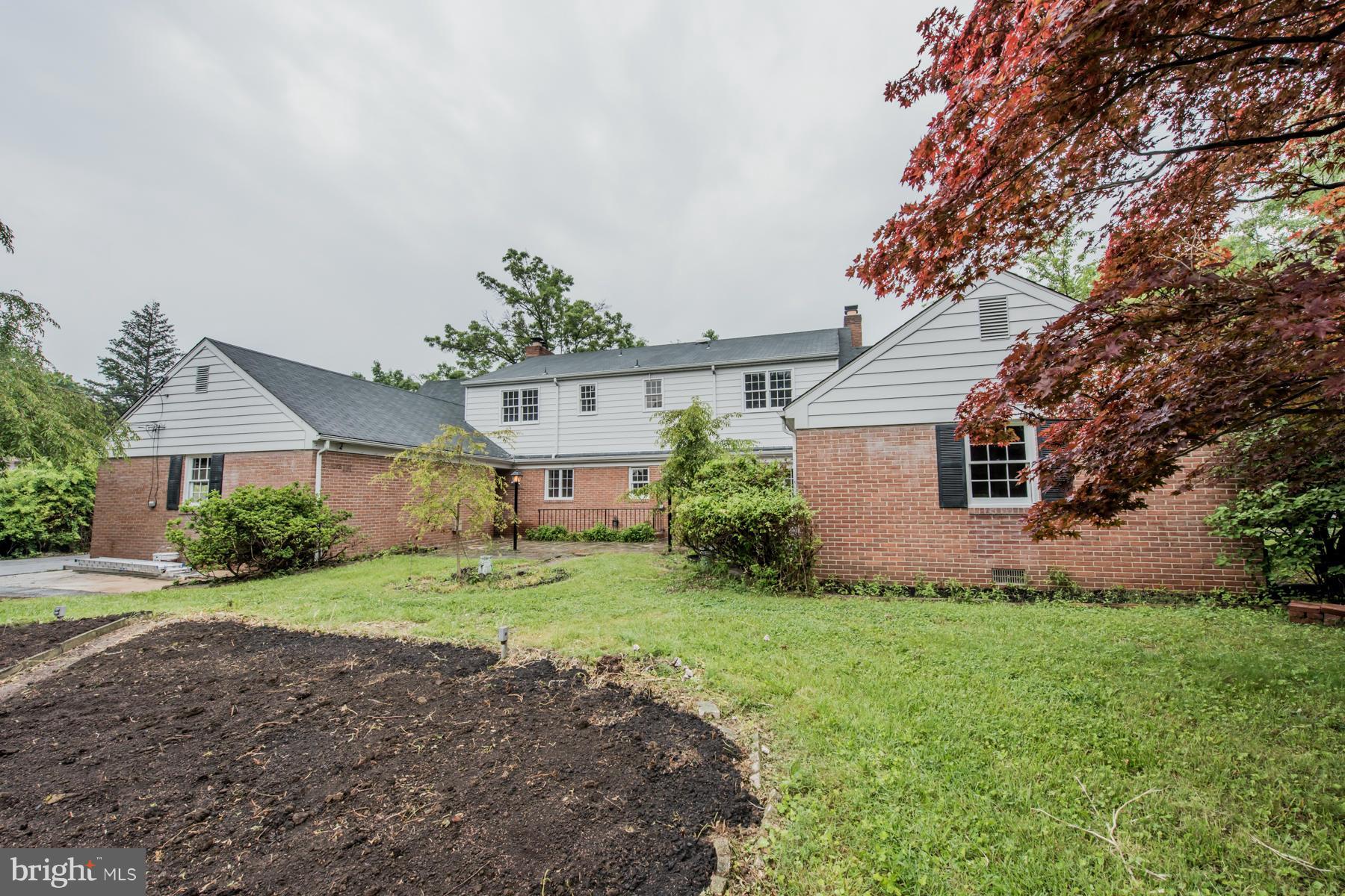 9105 Waycross Road Ellicott City, MD 21042 - Photo 24 of 27 a front view of a house with a yard and garage