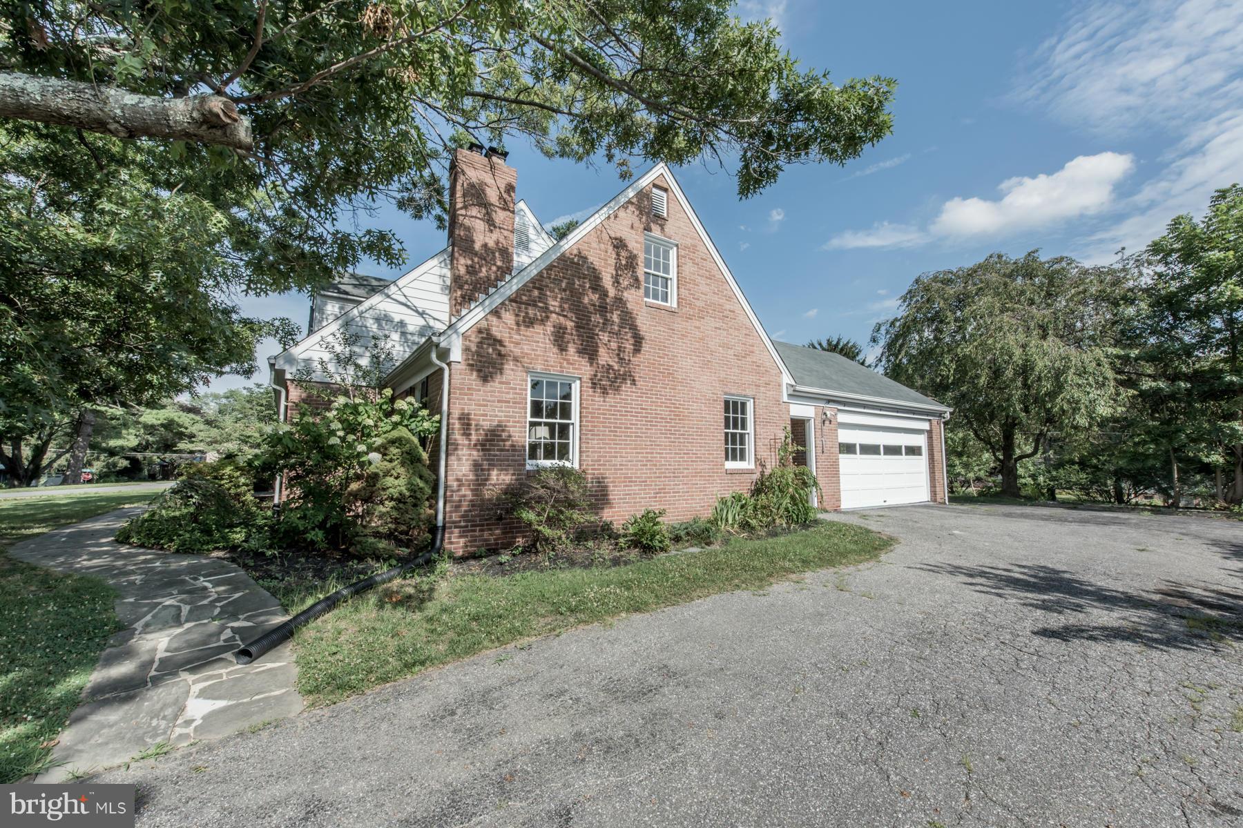 9105 Waycross Road Ellicott City, MD 21042 - Photo 25 of 27 a view of a house with a yard and large trees