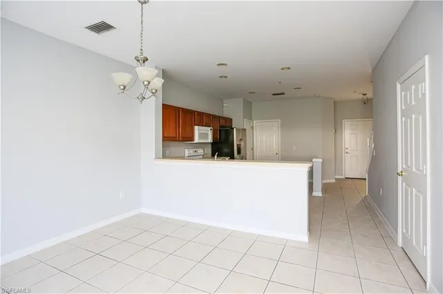 a view of a kitchen with a sink and a chandelier