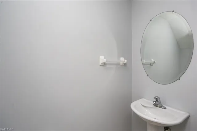 a bathroom with a sink and mirror