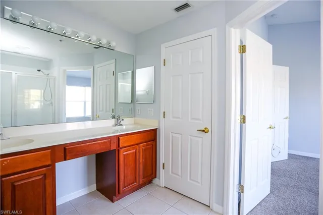 a large bathroom with a double vanity sink and a mirror