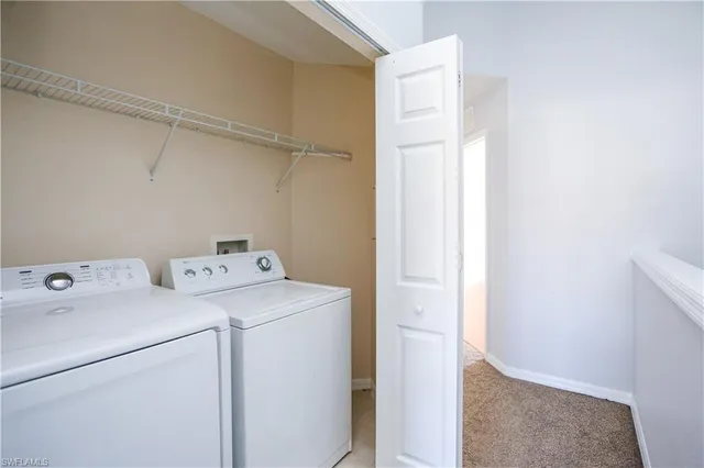 a view of storage and utility room with washer and dryer