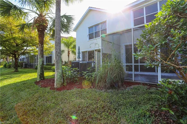 a view of backyard with potted plants and palm trees