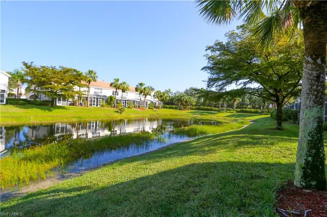 a view of a swimming pool with a garden and lake view