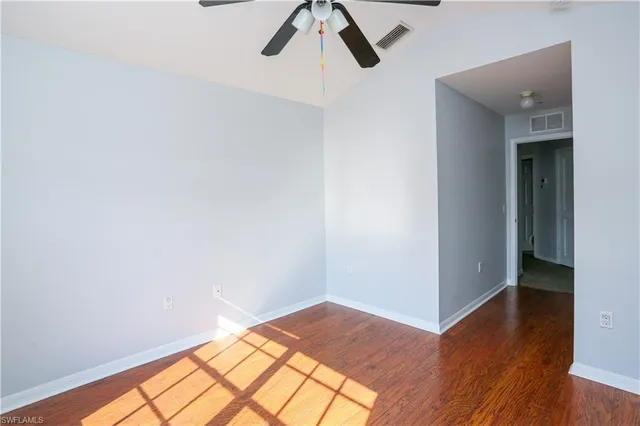 a view of a room with wooden floor and white walls
