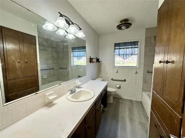 a bathroom with a sink a large mirror and shower