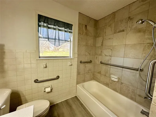 a bathroom with a sink a toilet and bathtub