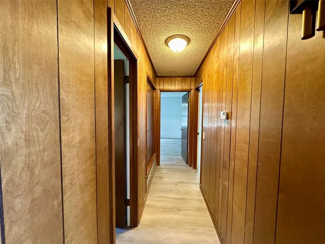 a view of a hallway with wooden door
