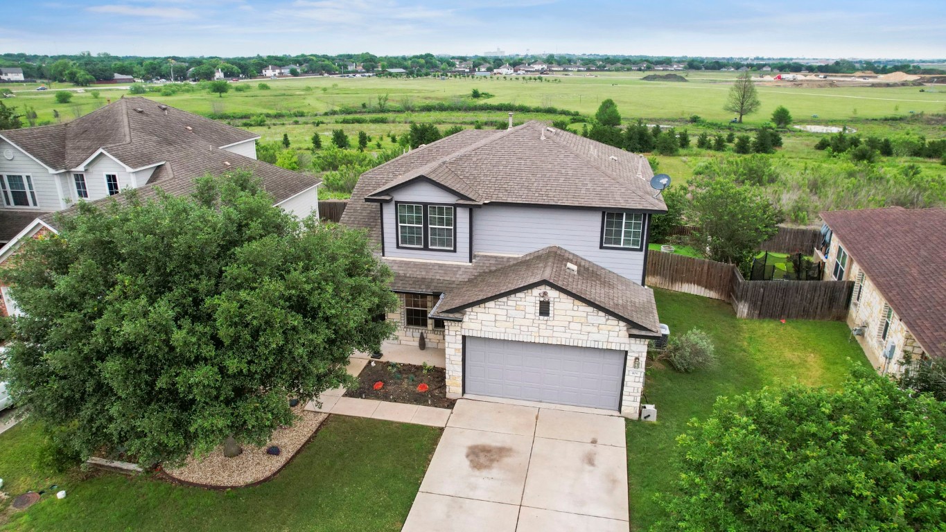 an aerial view of a house with yard