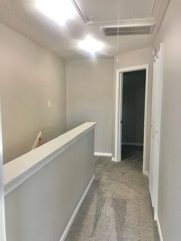 a view of an empty room with a ceiling fan