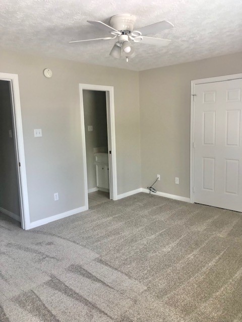 404 Peach Street, Unit 1 Tomball, TX 77375 - Photo 14 of 15 a view of an empty room with a ceiling fan