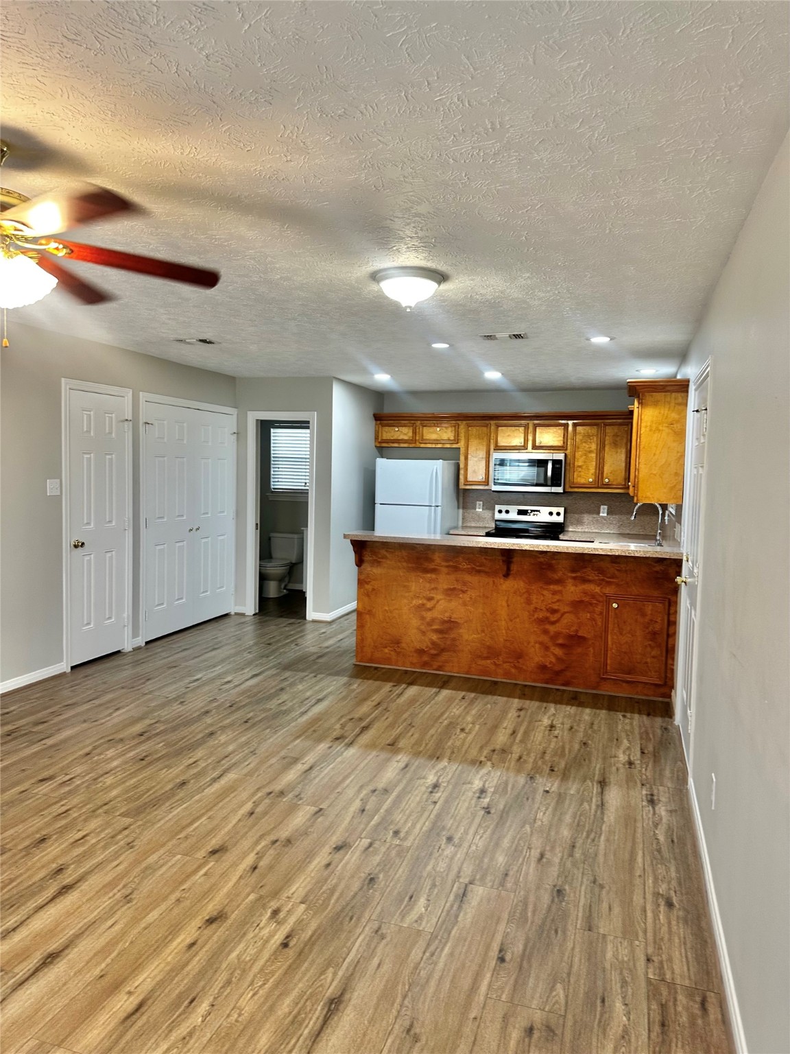 404 Peach Street, Unit 1 Tomball, TX 77375 - Photo 10 of 15 a view of a kitchen with a sink and a stove