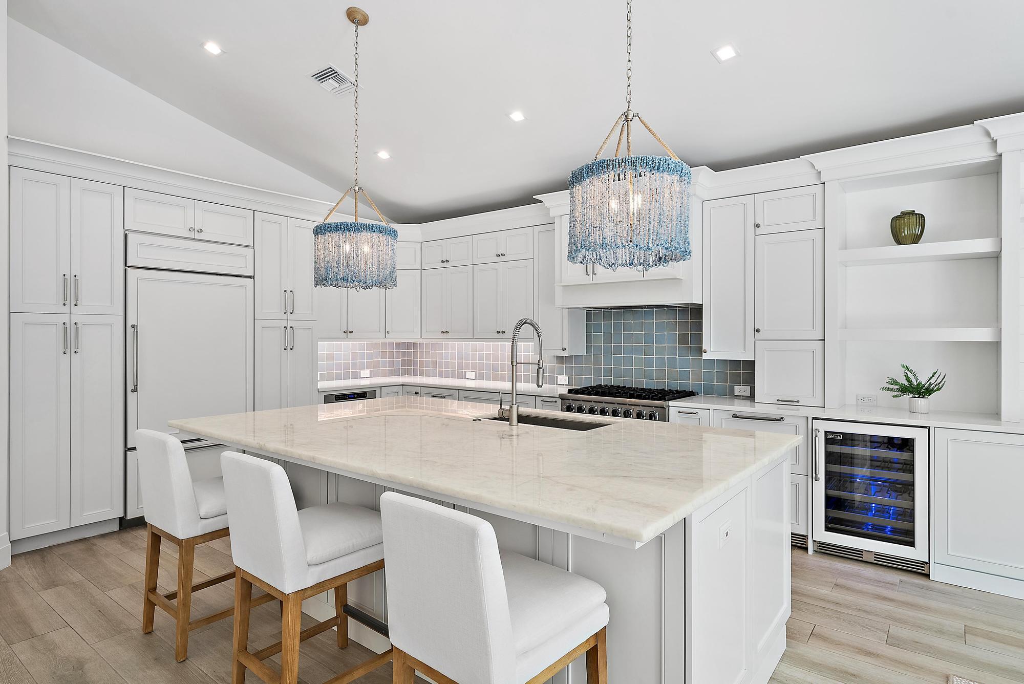 189 Shelter Lane Jupiter Inlet Colony, FL 33469 - Photo 13 of 48 a kitchen with a dining table chairs stainless steel appliances and cabinets